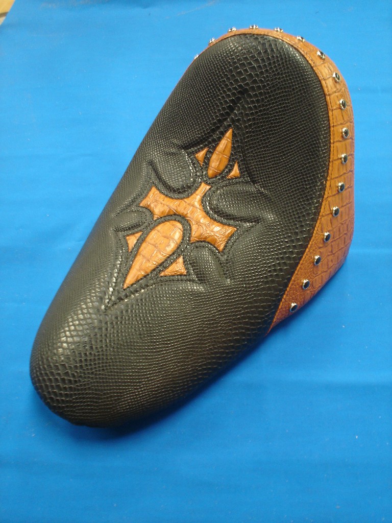 Solo seat in snakeskin-pattern cover with a tan cross inlay