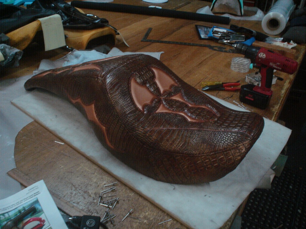 Hand-tooled two-up seat in brown gator on the workbench